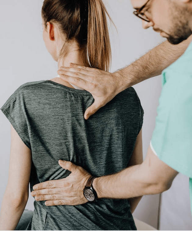 Doctor adjusting patients back